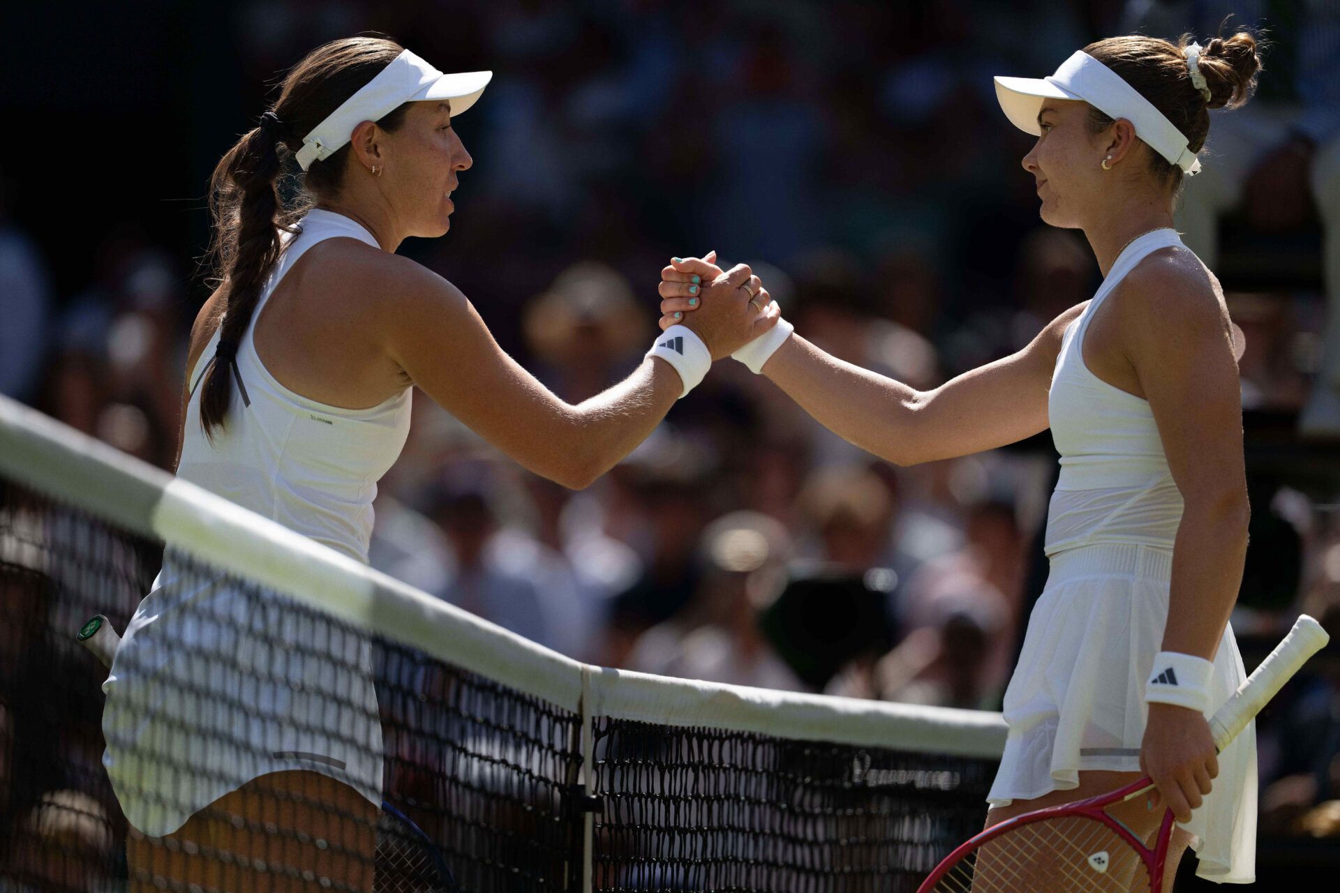 Jessica Pegula of the United States at the net with Iva Jovic of the United States after their match on day seven at All England Lawn Tennis and Croquet Club.