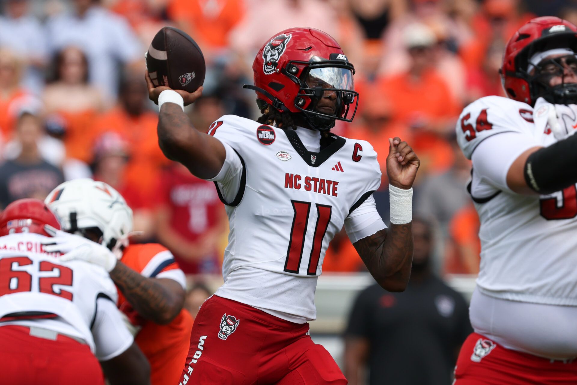 North Carolina State Wolfpack quarterback CJ Bailey (11) passes the ball in the first quarter against the Virginia Cavaliers at Scott Stadium.