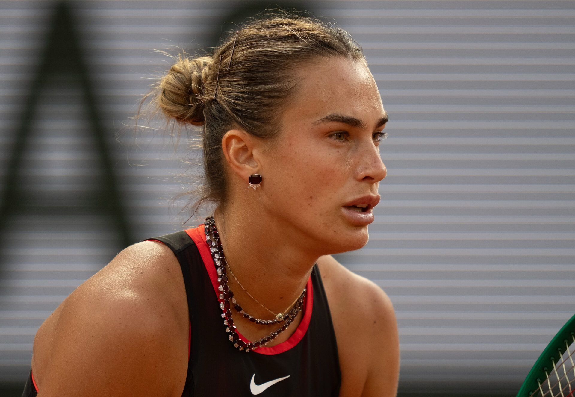 Aryna Sabalenka wearing her custom 24K diamond necklace during her match against Naomi Osaka of Japan on day nine at Stade Roland Garros.
