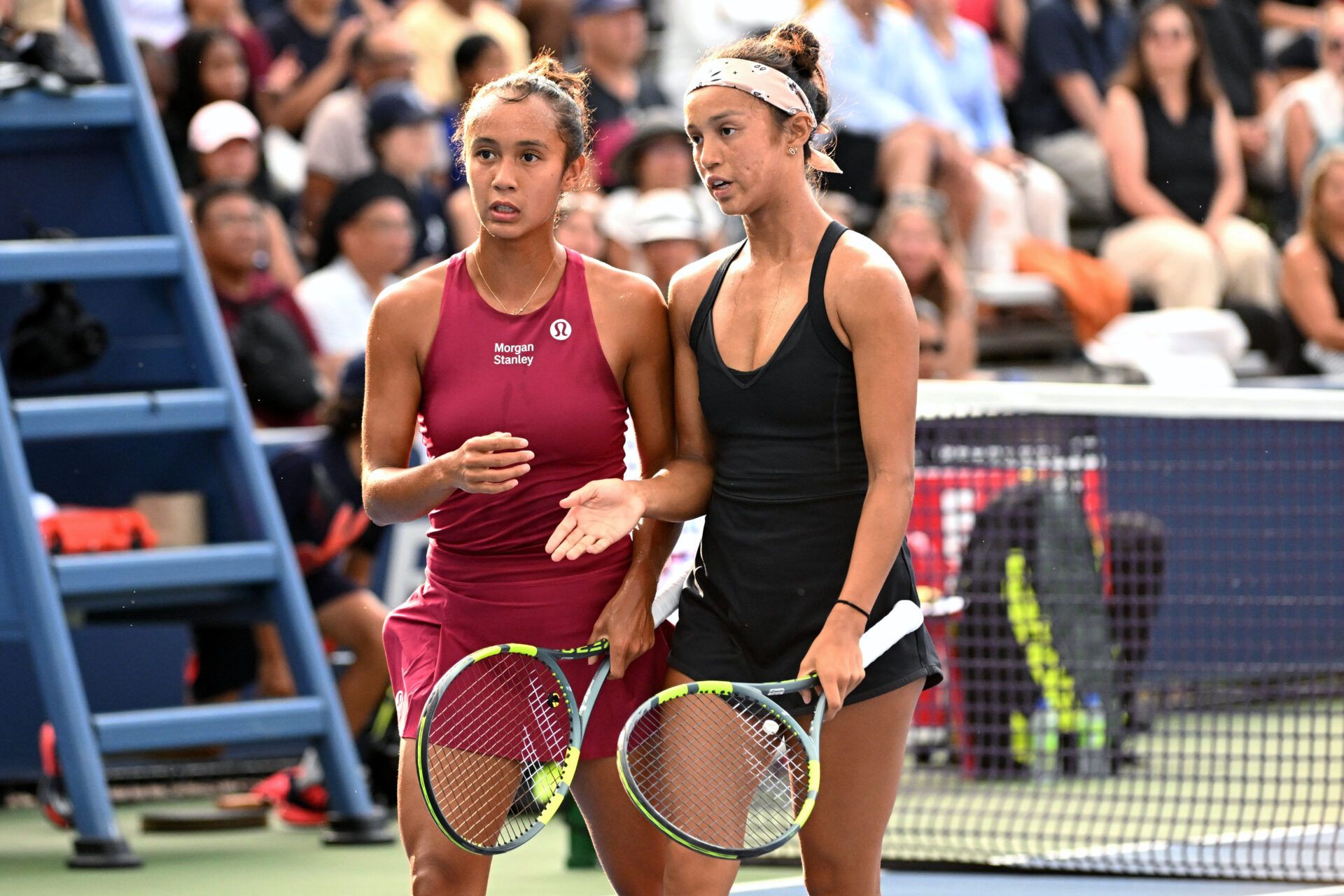 Leylah Fernandez (CAN, left) and Bianca Fernandez (CAN) look on in doubles play against Elise Mertens (BEL) and Diana Shnaider during third round play at Sobeys Stadium.