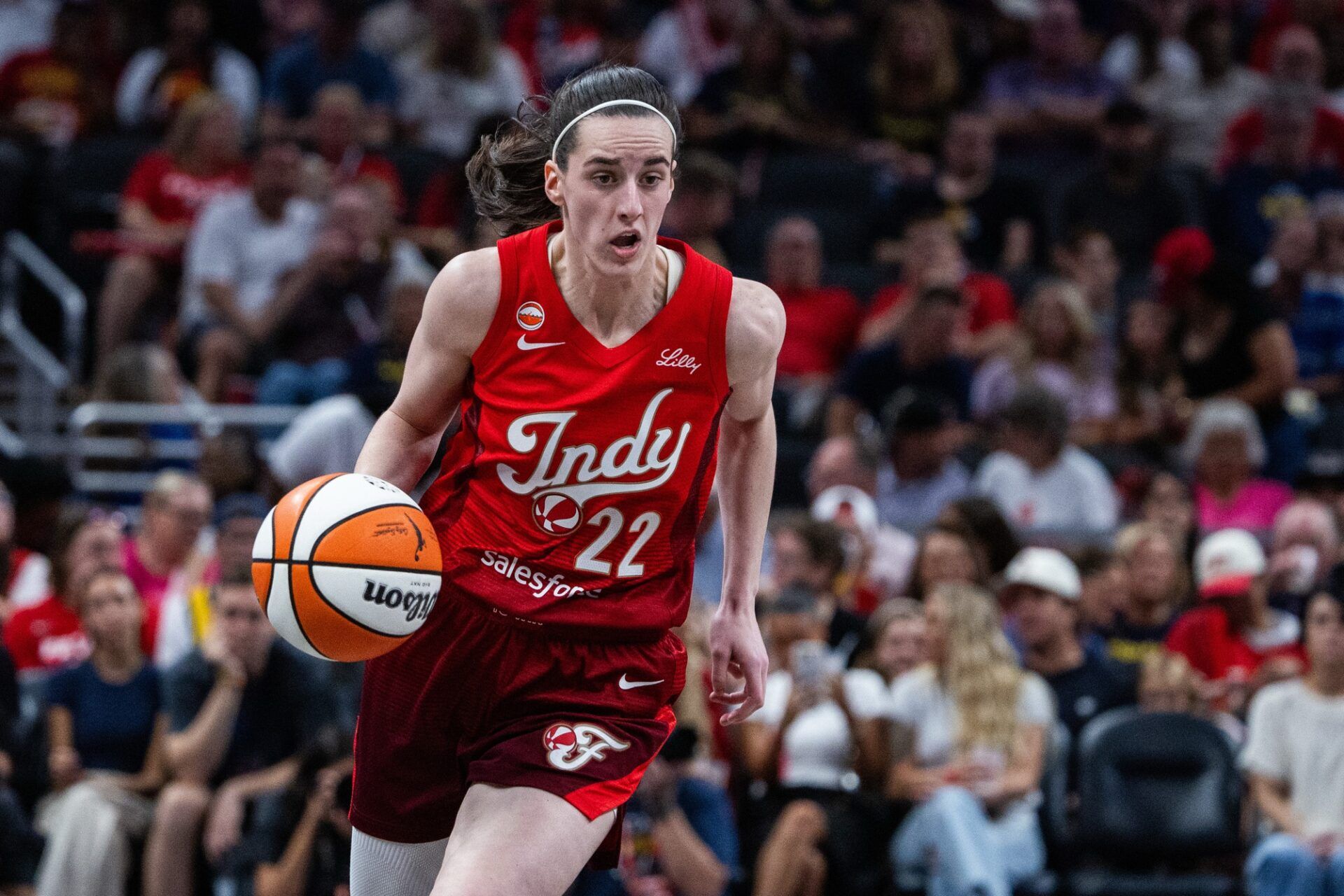 Indiana Fever guard Caitlin Clark (22) dribbles the ball in the second half against the Connecticut Sun at Gainbridge Fieldhouse.