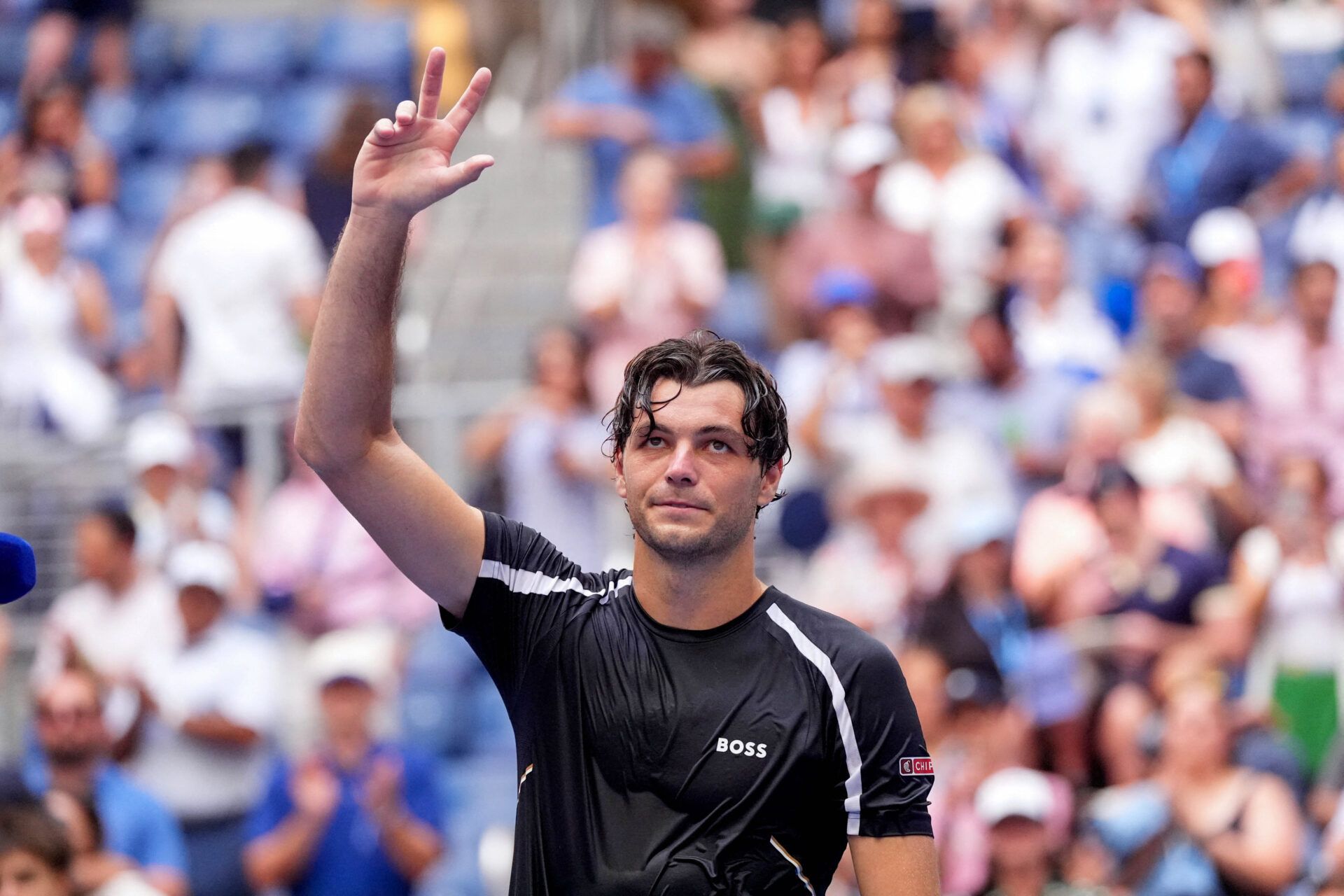 Taylor Fritz of the U.S. celebrates winning his second round match against Italy's Mattia Bellucci.
