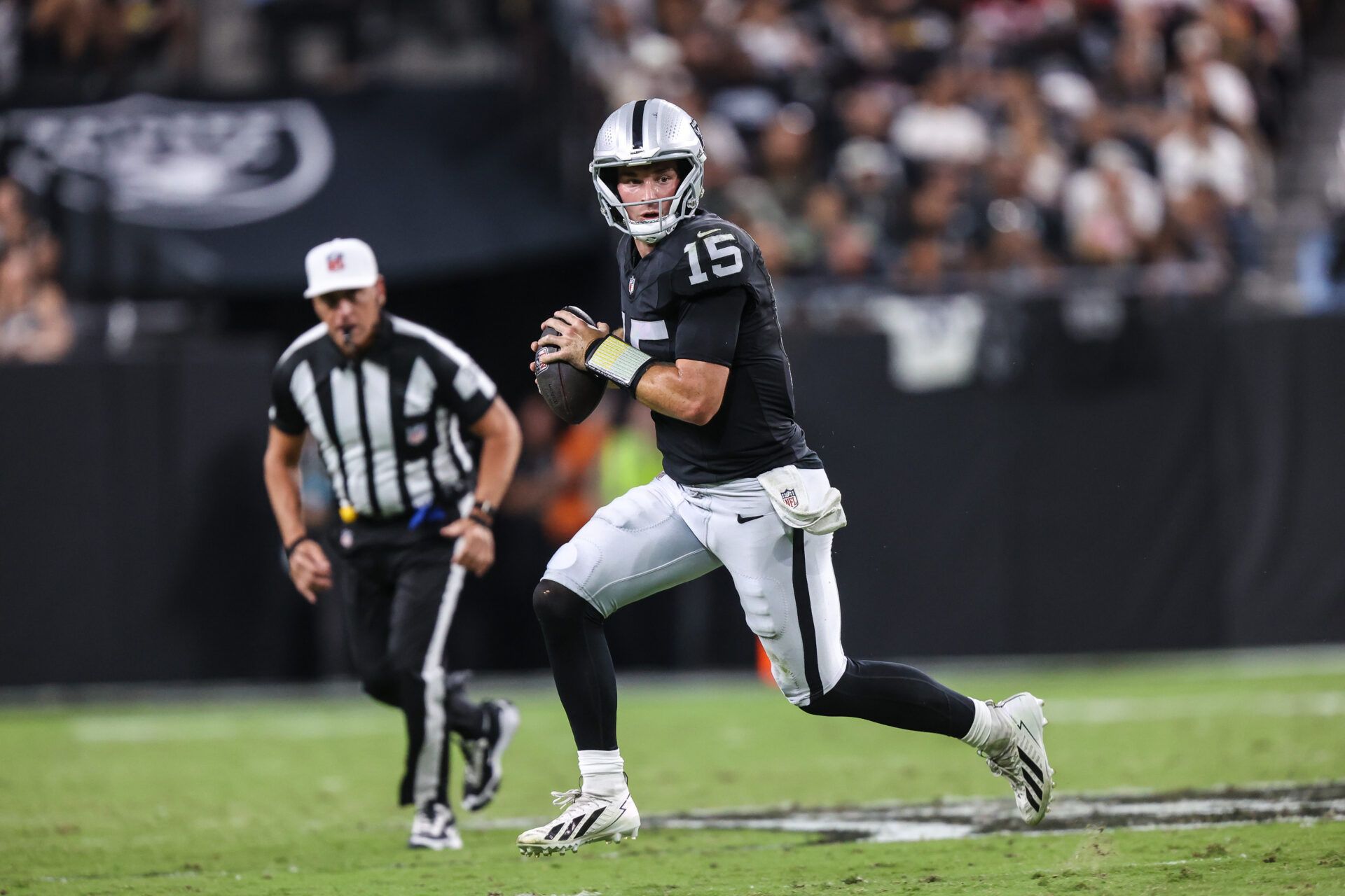Las Vegas Raiders quarterback Fernando Mendoza (15) rolls out of the pocket against the San Francisco 49ers during the second half at Allegiant Stadium.