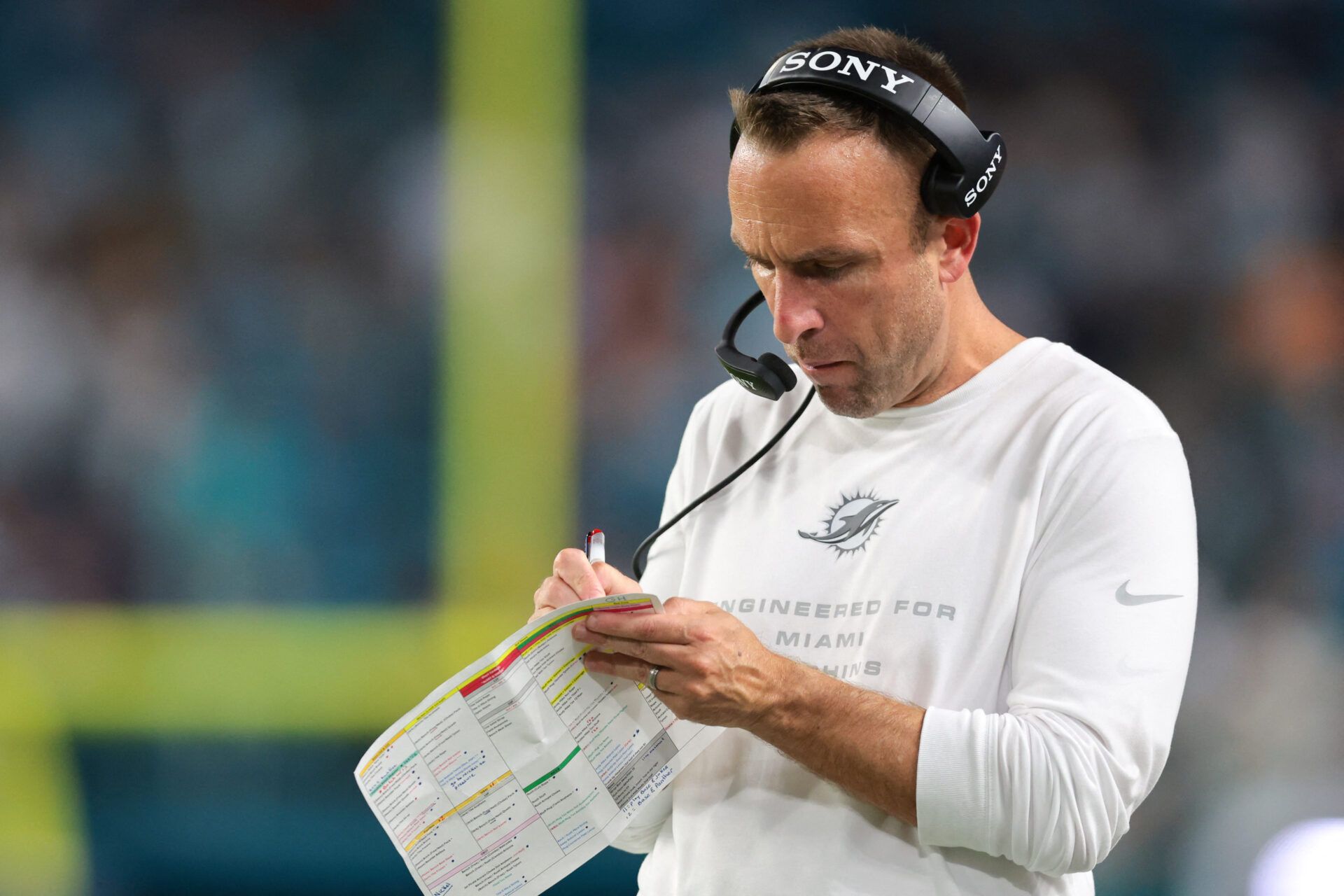Miami Dolphins head coach Jeff Hafley takes notes against the Atlanta Falcons during the second quarter at Hard Rock Stadium.