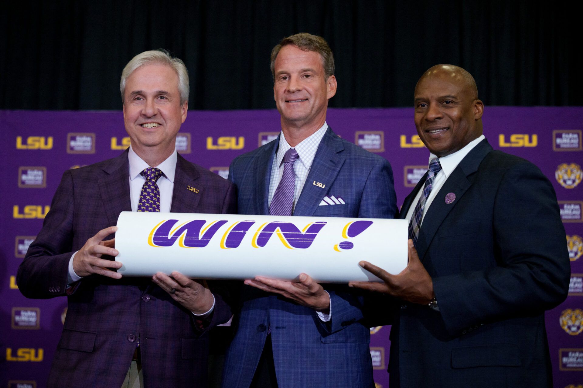 LSU president Wade Rousse, left, LSU new head coach Lane Kiffin and LSU athletic director Verge Ausberry stand together at South Stadium Club at Tiger Stadium.