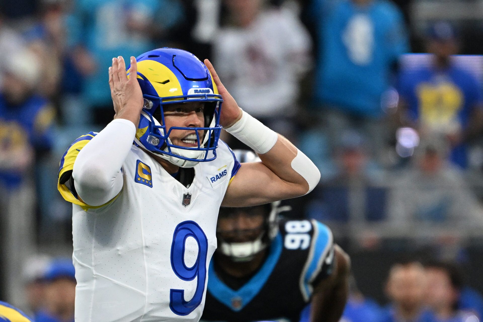 Los Angeles Rams quarterback Matthew Stafford (9) changes signals at the line in the first quarter in an NFC Wild Card Round game at Bank of America Stadium.