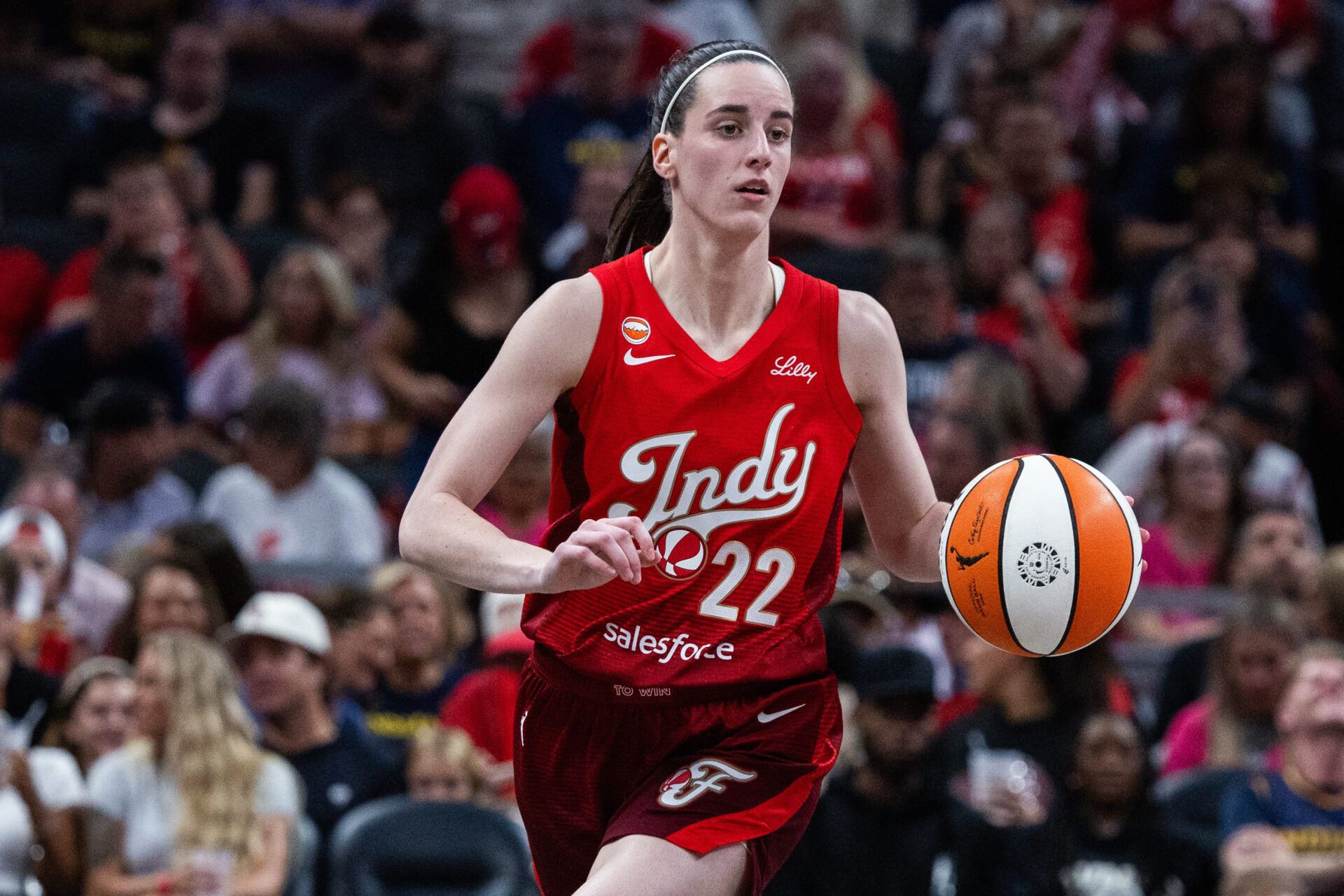 Indiana Fever guard Caitlin Clark (22) dribbles the ball in the second half against the Connecticut Sun at Gainbridge Fieldhouse.
