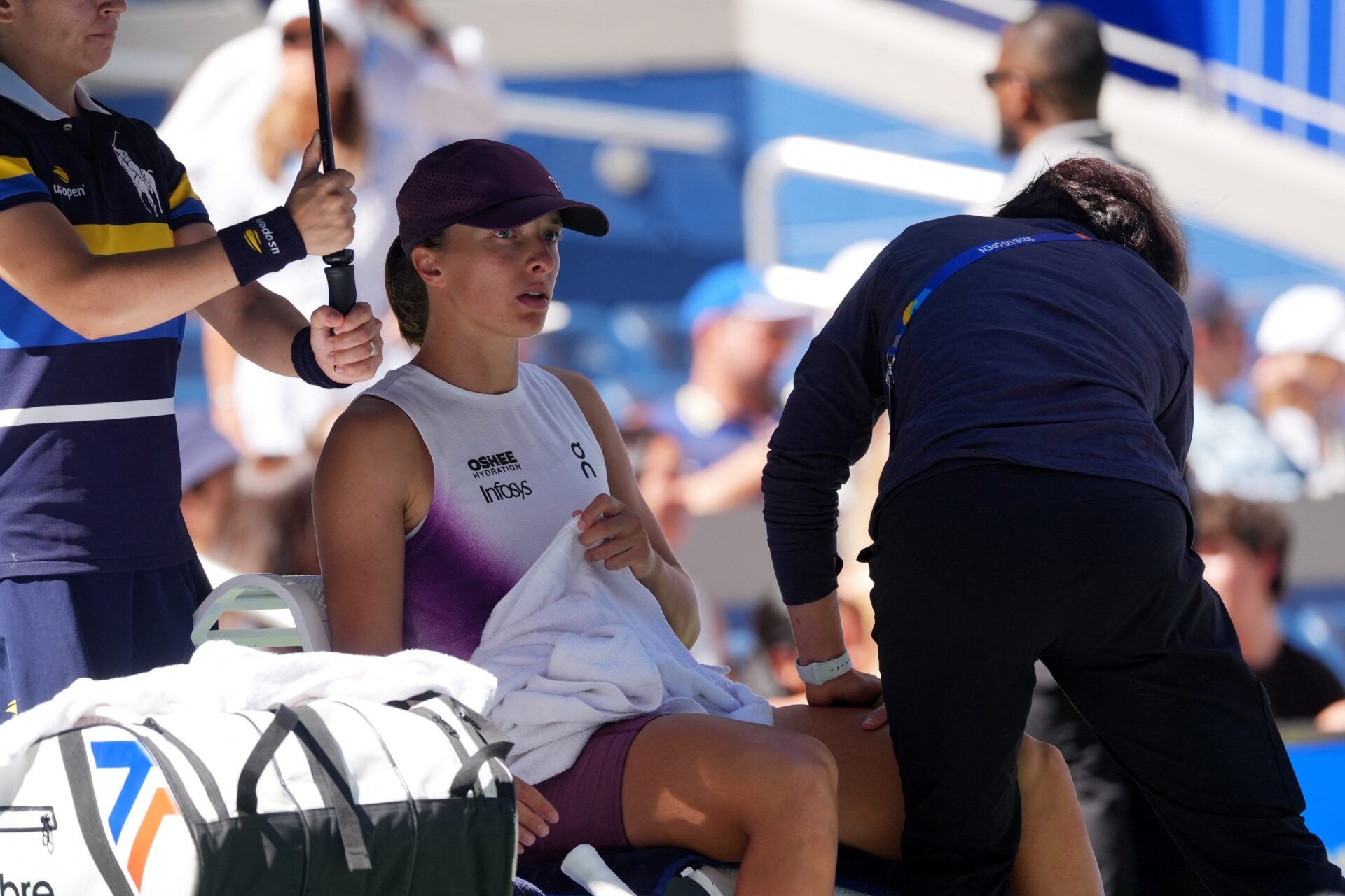 Poland's Iga Swiatek gets medical attention during a break in play in her round of 16 match against China's Qinwen Zheng.