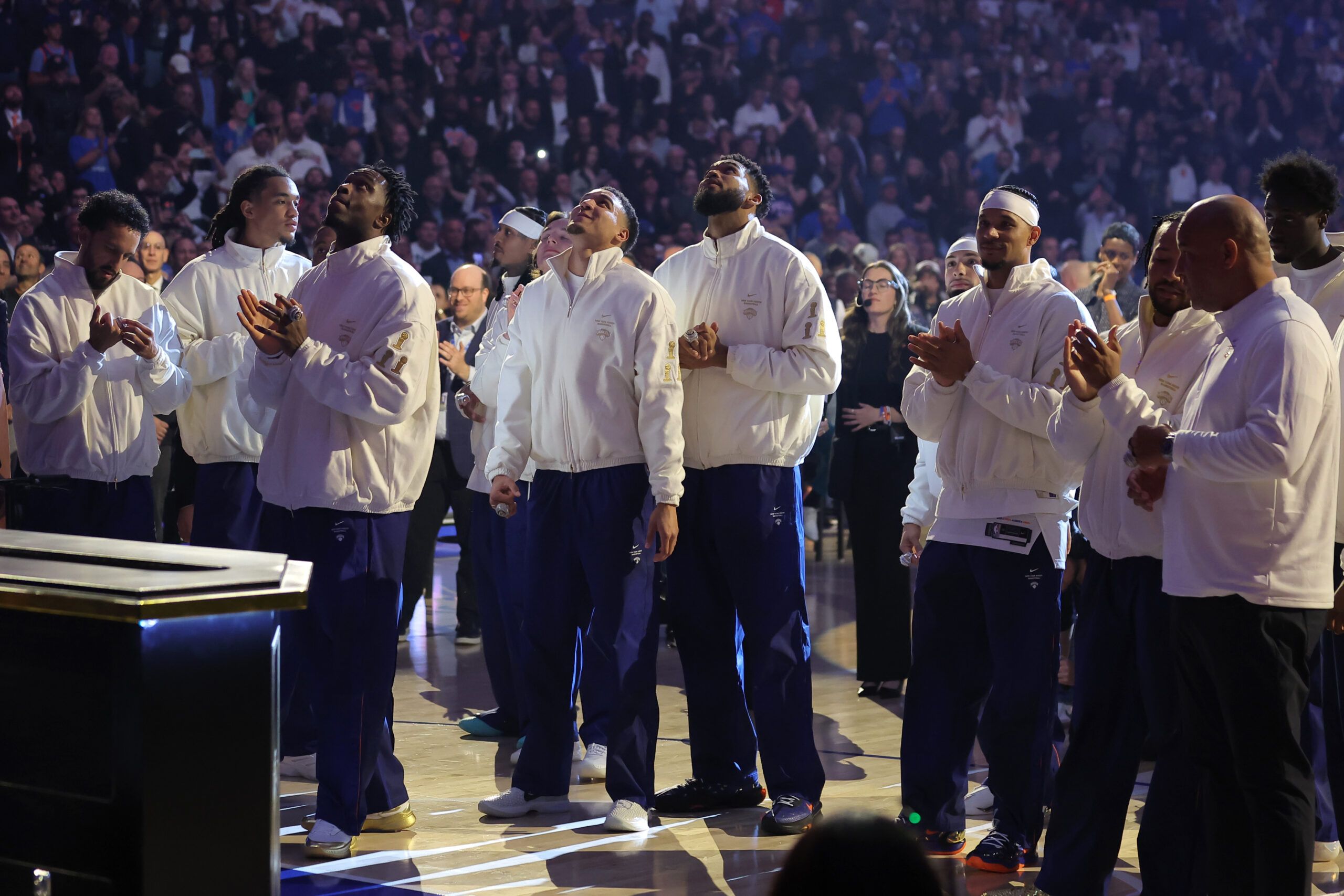 New York Knicks players watch their 2025-26 championship banner ascend to the rafters during a ceremony before opening night game against the Philadelphia 76ers at Madison Square Garden.